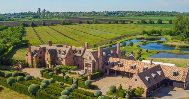 A sky view of a alrge brick building complex surrounded by countryside