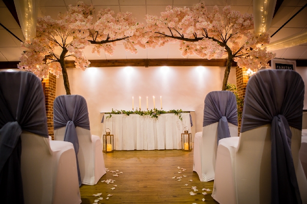 A cherry blossom flower arch framing an aisle