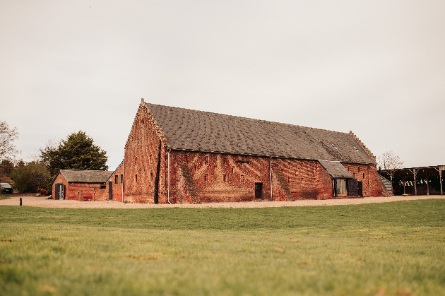 A large barn surrounded by a manicured lawn