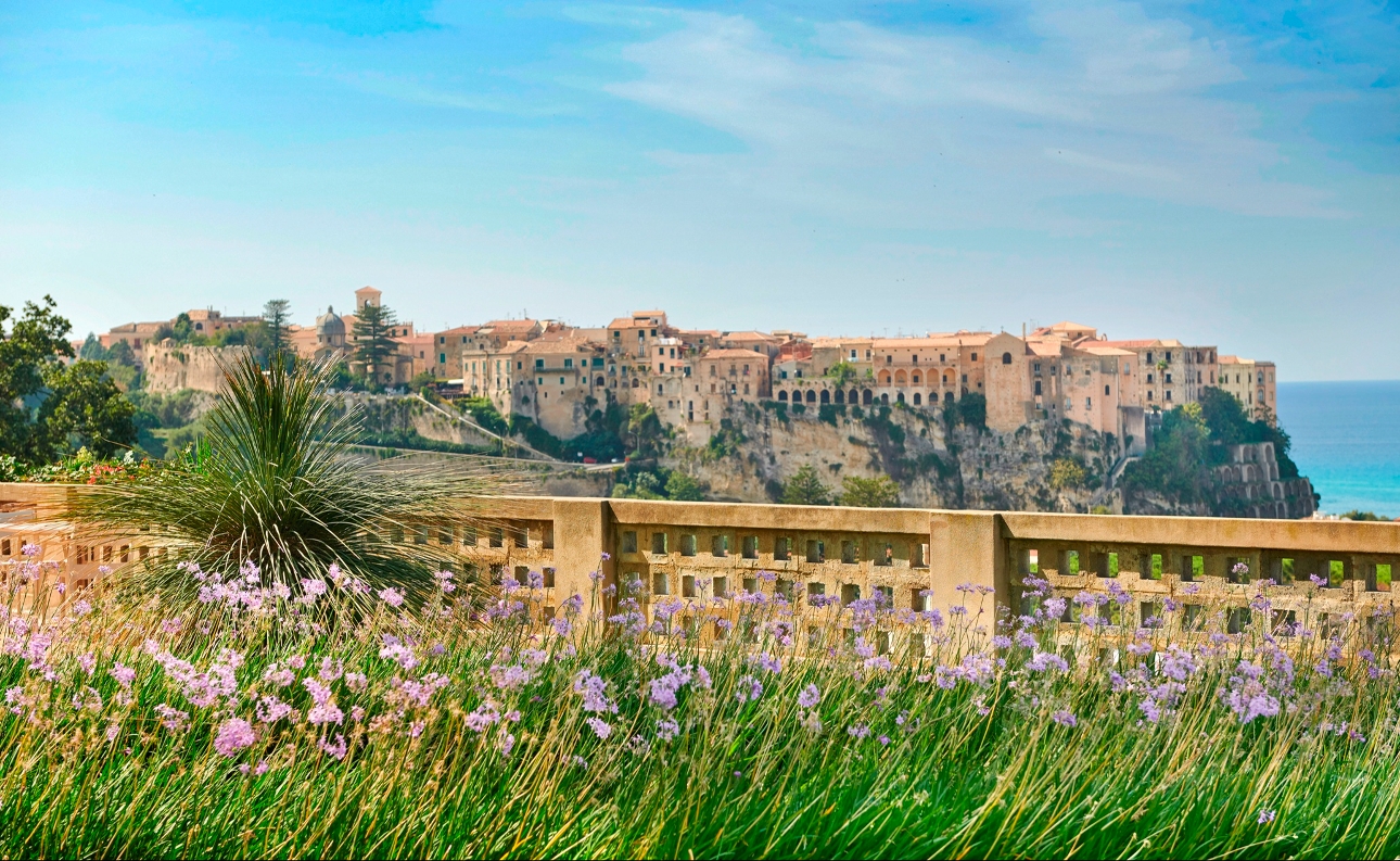 The exterior of a collection of buildings overlooking the sea