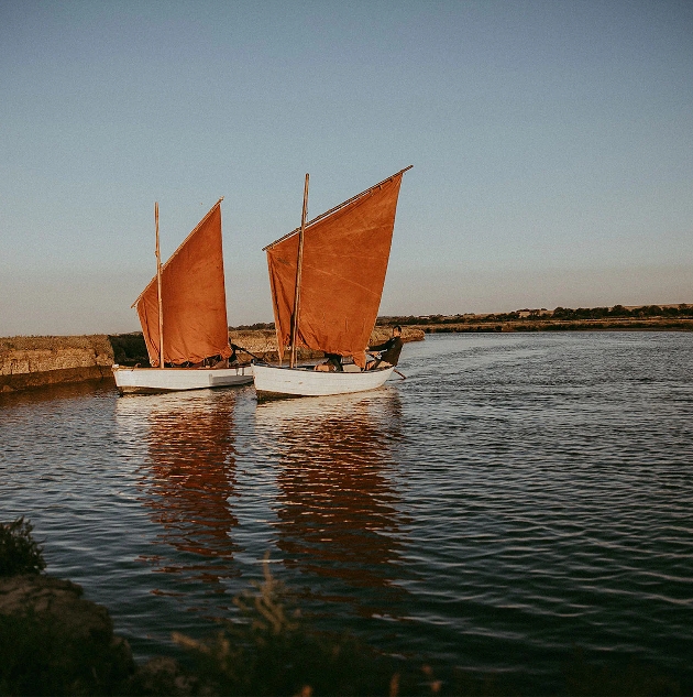 Two sailing boats with red sails