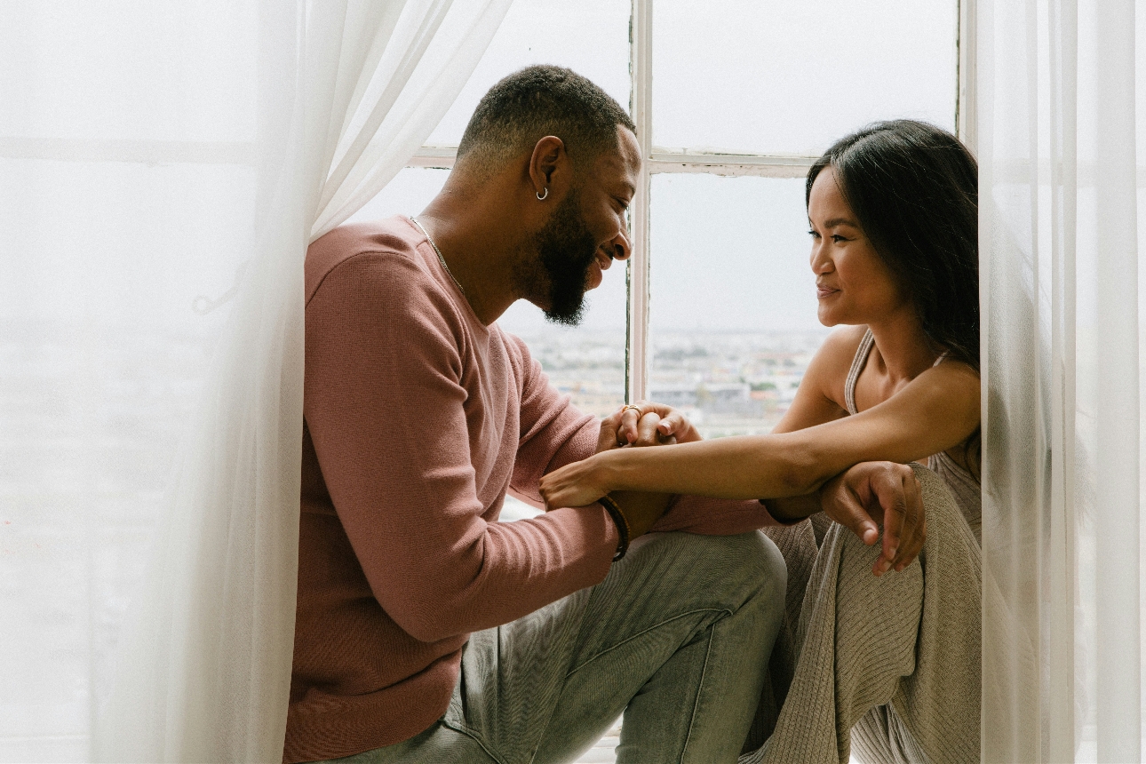 couple embraced on a window ledge