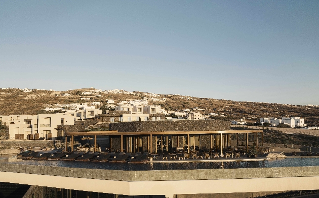 The exterior of a hotel at the bottom of a hill