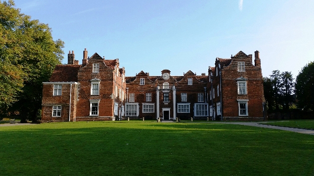 The exterior of a red brick mansion