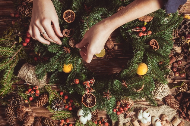 A person making a Christmas wreath