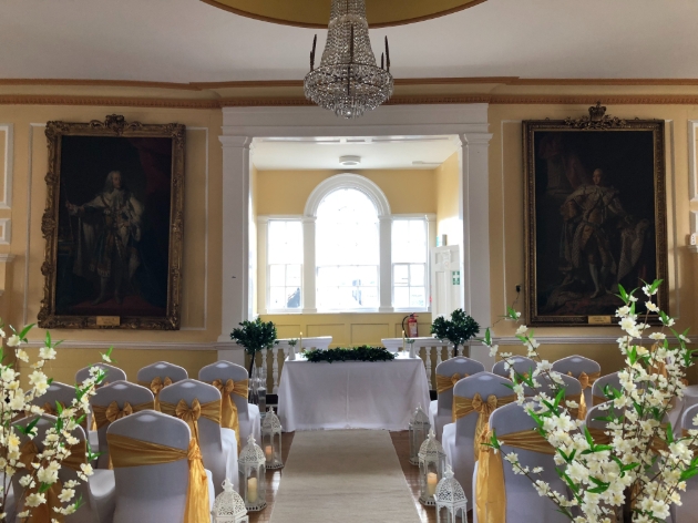 A yellow room with chairs lining an aisle