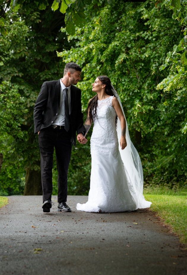 wedding couple walking along a path